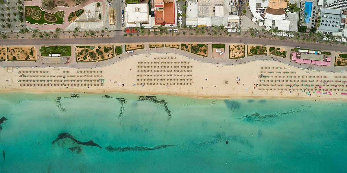 Aerial view of the turquoise sea and long sandy beach at S'Arenal