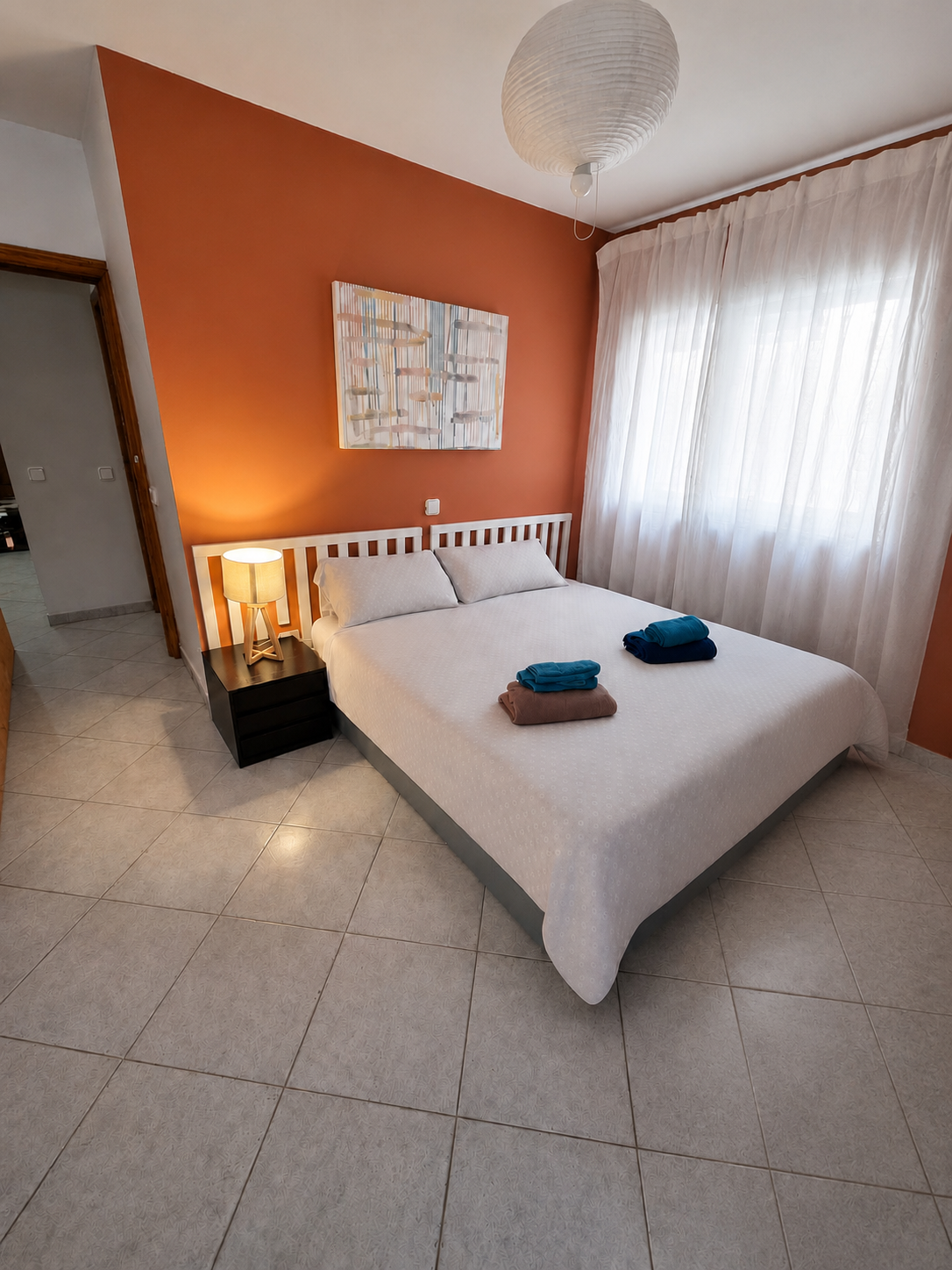 Private Deluxe Room with terracotta accent wall and double bed
