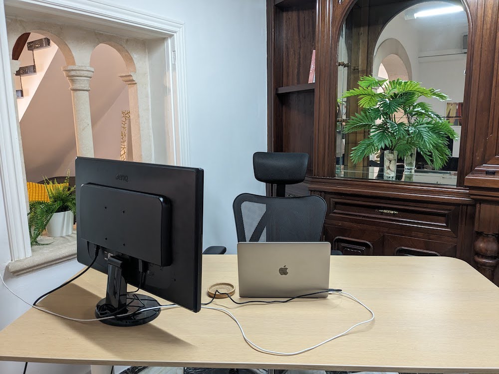 Hot desk with external monitor and ergonomic chair