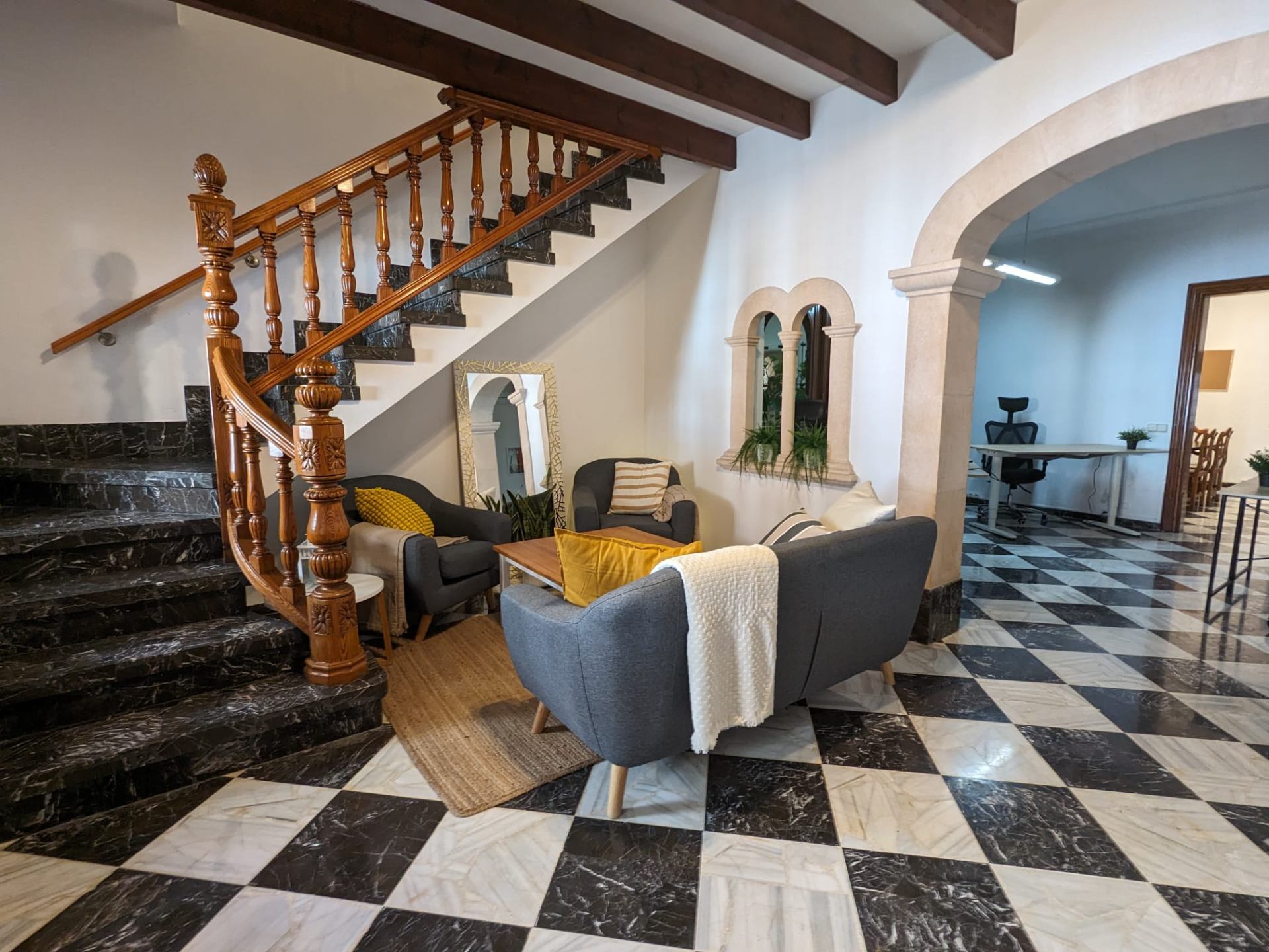 Living room with staircase and coworking area
